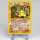 an original holographic charizard card set against an off white background